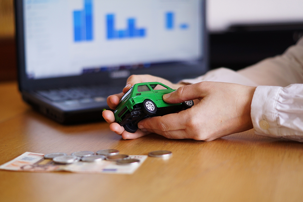 Closeup shot of a person thinking of buying a new car or selling a vehicle